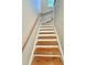 Wooden staircase with white risers and wooden handrail leading to the upper level at 508 & 510 Gordon St, Roxboro, NC 27573
