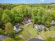 An aerial view of a white single-Gathering home nestled among lush green trees at 508 Baygall Rd, Holly Springs, NC 27540