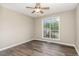 Bright bedroom featuring wood-look floors, a ceiling fan and a bright window at 508 Baygall Rd, Holly Springs, NC 27540