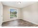Bright bedroom featuring wood floors and a large window with a view of the outdoors at 508 Baygall Rd, Holly Springs, NC 27540