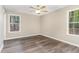 Bedroom featuring wood-look floors, a ceiling fan and a bright window at 508 Baygall Rd, Holly Springs, NC 27540