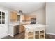 Kitchen with stainless steel appliances, light wood cabinets and a kitchen island at 508 Baygall Rd, Holly Springs, NC 27540