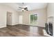 Bright living room with wood-look flooring, a fireplace, and a large window at 508 Baygall Rd, Holly Springs, NC 27540