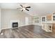 Spacious living room featuring a fireplace, ceiling fan, and wood-look flooring at 508 Baygall Rd, Holly Springs, NC 27540