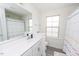 Bright bathroom with a single sink vanity and a shower with colorful curtain at 512 Oak Holly Ln, Zebulon, NC 27597