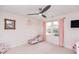Cozy bedroom with a ceiling fan, natural light and a window view at 512 Oak Holly Ln, Zebulon, NC 27597