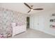 Charming bedroom with decorative wallpaper, ceiling fan and built-in storage at 512 Oak Holly Ln, Zebulon, NC 27597