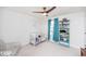 Well-lit bedroom featuring a crib, comfortable chair, and bookshelf at 512 Oak Holly Ln, Zebulon, NC 27597