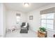 Bedroom provides two windows, an accent chair, and neutral colors at 512 Oak Holly Ln, Zebulon, NC 27597