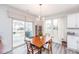 Bright dining area featuring a sliding door to patio and modern light fixture at 512 Oak Holly Ln, Zebulon, NC 27597