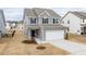 Beautiful two-story home boasting a two-car garage, stone entryway, and landscaped front yard at 512 Oak Holly Ln, Zebulon, NC 27597