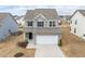 Beautiful two-story home with a driveway, manicured lawn, and gray siding in a residential neighborhood at 512 Oak Holly Ln, Zebulon, NC 27597