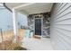 Inviting front porch featuring a stylish door, stone accents, and a cozy seating area at 512 Oak Holly Ln, Zebulon, NC 27597