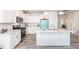 Modern kitchen boasting white cabinetry, granite countertops, stainless steel appliances, and wood-look flooring at 512 Oak Holly Ln, Zebulon, NC 27597
