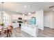 Bright kitchen with white cabinets, granite countertops, a central island, and stainless steel appliances at 512 Oak Holly Ln, Zebulon, NC 27597