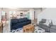 Cozy living room with wood-look floors, comfortable seating, and an open layout to the kitchen at 512 Oak Holly Ln, Zebulon, NC 27597