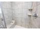 Close-up of the tiled shower with a built-in bench and shower caddy at 512 Oak Holly Ln, Zebulon, NC 27597