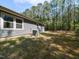 Exterior view of the home showcasing a spacious backyard with mature trees and AC unit at 519 Touchstone Dr, Durham, NC 27713