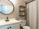 Modern bathroom features a sleek vanity with a circular mirror and a black and white shower curtain at 519 Touchstone Dr, Durham, NC 27713