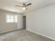 Cozy carpeted bedroom with a ceiling fan, neutral walls, and views from the window at 519 Touchstone Dr, Durham, NC 27713