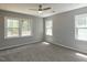 Spacious bedroom with multiple windows and plush carpet at 519 Touchstone Dr, Durham, NC 27713