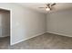 Spacious carpeted bedroom with a ceiling fan and door leading to another room at 519 Touchstone Dr, Durham, NC 27713
