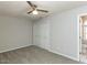 Comfortable bedroom with carpet, neutral walls, and a ceiling fan, adjacent to the ensuite bathroom at 519 Touchstone Dr, Durham, NC 27713