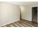 Bedroom featuring wood-look floors, neutral paint, and a nearby staircase at 519 Touchstone Dr, Durham, NC 27713