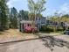 Inviting exterior of a well maintained townhouse showcasing mature landscaping and a lush surrounding environment at 519 Touchstone Dr, Durham, NC 27713