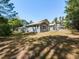 Exterior side view of the home showcasing its back yard, setting, and details at 519 Touchstone Dr, Durham, NC 27713