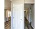 Bright hallway featuring modern wood-look flooring, fresh paint, and a view into adjoining rooms at 519 Touchstone Dr, Durham, NC 27713