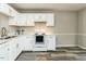 Cozy kitchen with white cabinetry, modern countertops, and stainless steel appliances at 519 Touchstone Dr, Durham, NC 27713