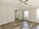 Bright living room features wood-look floors and large windows with sheer curtains at 519 Touchstone Dr, Durham, NC 27713