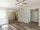 Spacious living room with wood-look flooring, a modern ceiling fan, and an open layout at 519 Touchstone Dr, Durham, NC 27713