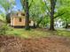 Spacious backyard featuring mature trees, lush grass, and a view of the home's rear exterior at 524 S Boylan Ave, Raleigh, NC 27603