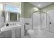 Clean bathroom featuring a pedestal sink, tiled shower, and a window offering natural light at 524 S Boylan Ave, Raleigh, NC 27603