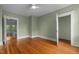 Spacious bedroom featuring hardwood floors, natural light, and an open doorway leading to an adjacent room at 524 S Boylan Ave, Raleigh, NC 27603