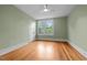 Sunny bedroom with natural light streaming in through the windows, highlighting the hardwood floors and neutral walls at 524 S Boylan Ave, Raleigh, NC 27603