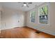 Bright bedroom with hardwood floors, fresh paint, ceiling fan, and two windows providing natural light and views at 524 S Boylan Ave, Raleigh, NC 27603