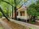 Side view of home with a white picket fence and mature trees along the property line at 524 S Boylan Ave, Raleigh, NC 27603