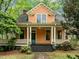 Charming two-story home showcasing a welcoming front porch with classic columns and a well-manicured lawn at 524 S Boylan Ave, Raleigh, NC 27603