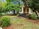 Charming peach home features a welcoming porch with white columns and a lush landscaped front yard at 524 S Boylan Ave, Raleigh, NC 27603