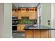Modern kitchen with stainless steel appliances, light wood cabinets, and dark countertops at 524 S Boylan Ave, Raleigh, NC 27603