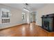 Living room with hardwood floors, fireplace, fan, and view to other rooms at 524 S Boylan Ave, Raleigh, NC 27603