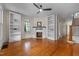 Open living room boasts hardwood floors, fireplace, built-in shelving, staircase and natural light at 524 S Boylan Ave, Raleigh, NC 27603