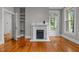 Bright living room with hardwood floors, classic fireplace, and access to an outdoor space at 524 S Boylan Ave, Raleigh, NC 27603