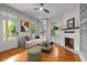 Bright living room with hardwood floors, fireplace, built-in shelving, and a ceiling fan, offers a cozy and inviting space at 524 S Boylan Ave, Raleigh, NC 27603