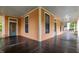 Wraparound porch showcasing dark flooring, stately columns, and inviting access points to the charming home at 524 S Boylan Ave, Raleigh, NC 27603
