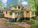 Rear exterior view of a two-story home with a private balcony, wooden deck and stairs at 524 S Boylan Ave, Raleigh, NC 27603