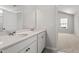 Bathroom featuring double sinks with stylish hardware and a large framed mirror at 54 Grove Township Way, Angier, NC 27501